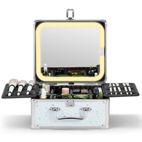 A makeup box with a lighted mirror and multiple compartments, some containing makeup brushes and cosmetic products, with a star pattern on the surface.
