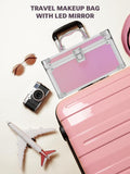 Pink travel makeup box with LED mirror, sunglasses, camera, and toy airplane on a light background