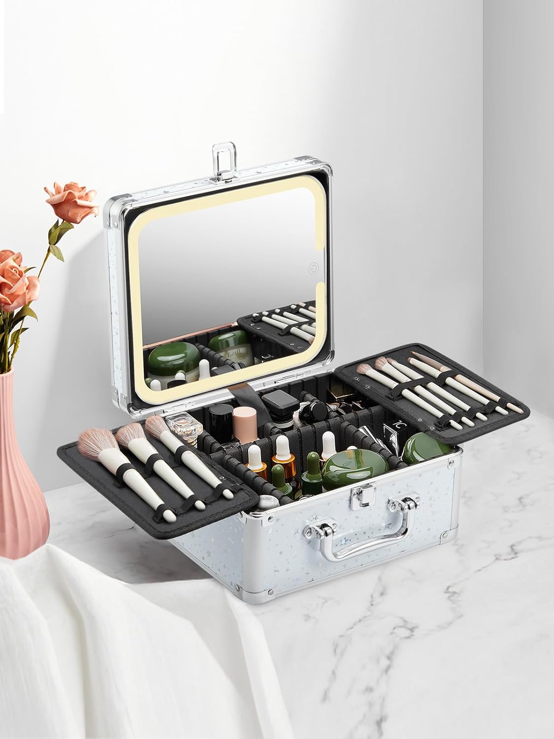 white makeup box with LED mirror on a marble surface and white background. Cosmetic items are neatly arranged inside the box