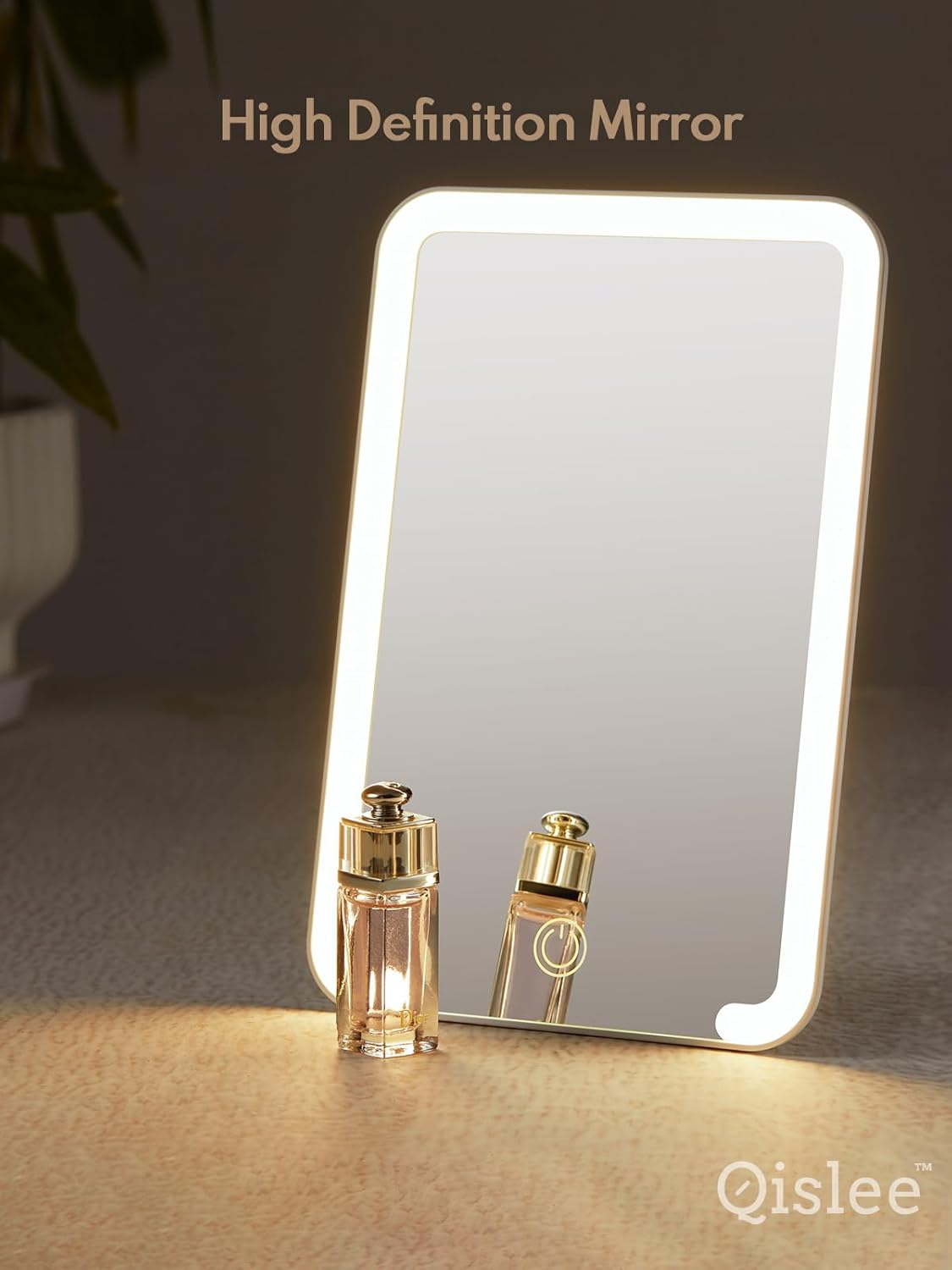 HD Lighted mirror standing on a brown surface with a bottle of perfume in front with its reflection visible