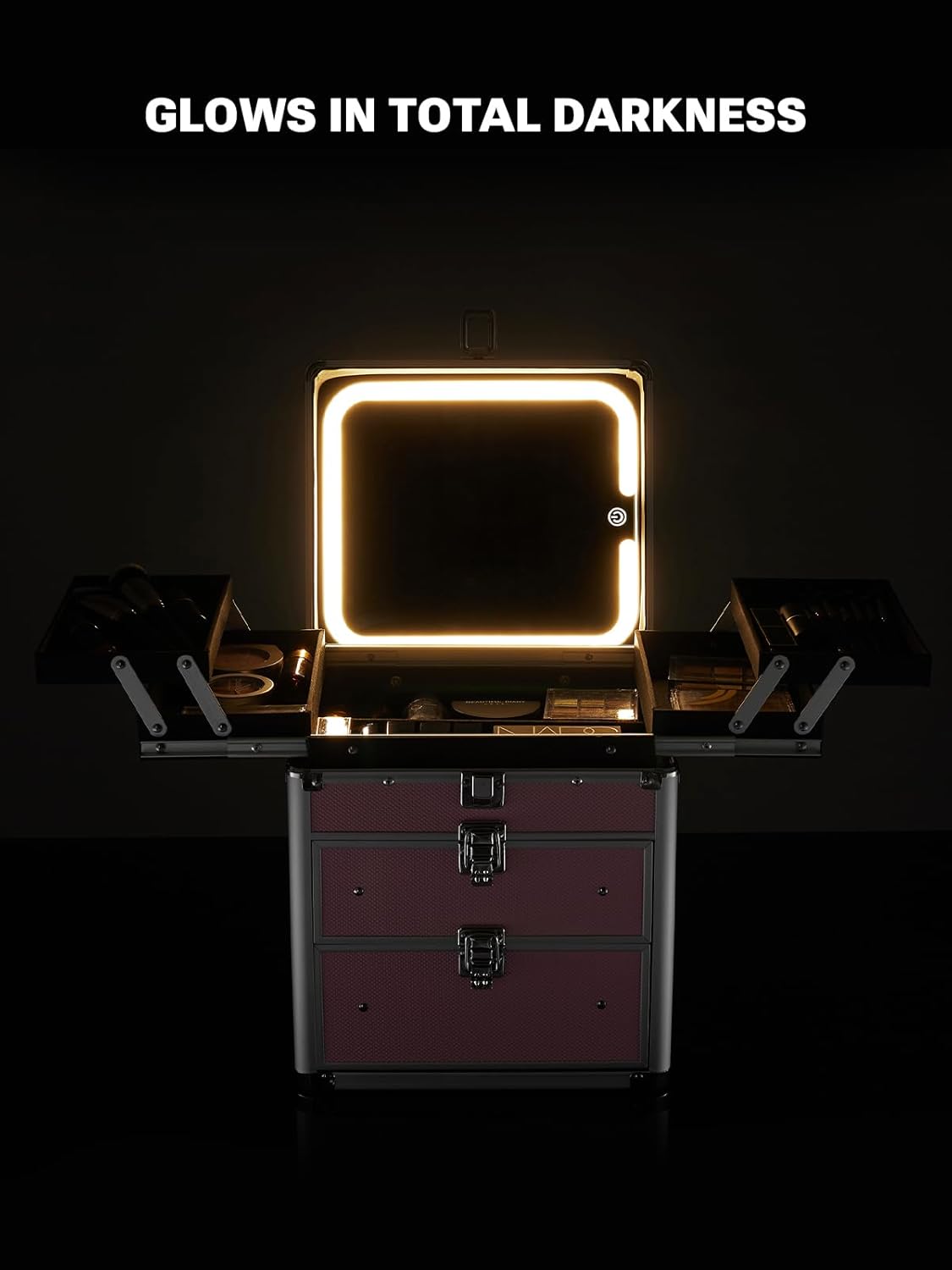 Makeup case with illuminated mirror on a dark background, labeled 'Glow in total darkness'.