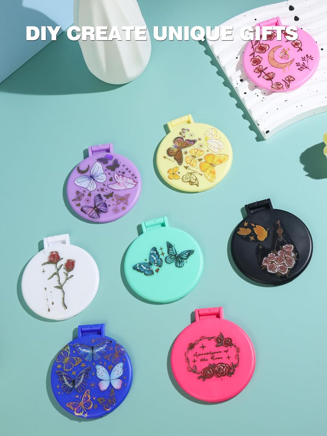 compact mirrors in different colors with butterflies and flowers on the cover