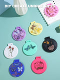 compact mirrors in different colors with butterflies and flowers on the cover