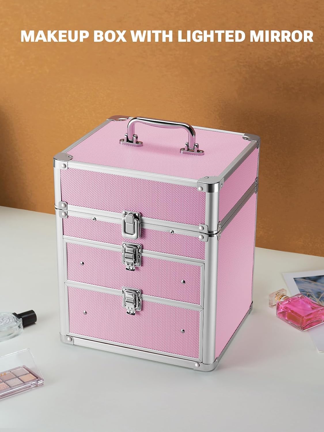 Pink makeup box with lighted mirror on a white surface with a brown background