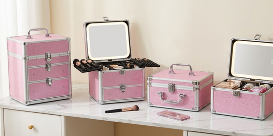 Pink makeup cases in different sizes on a marble table